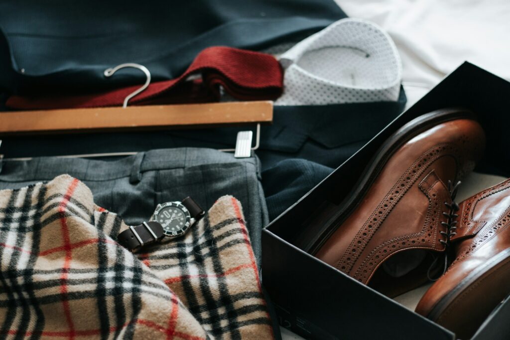 Clothes laid out on a bed. 