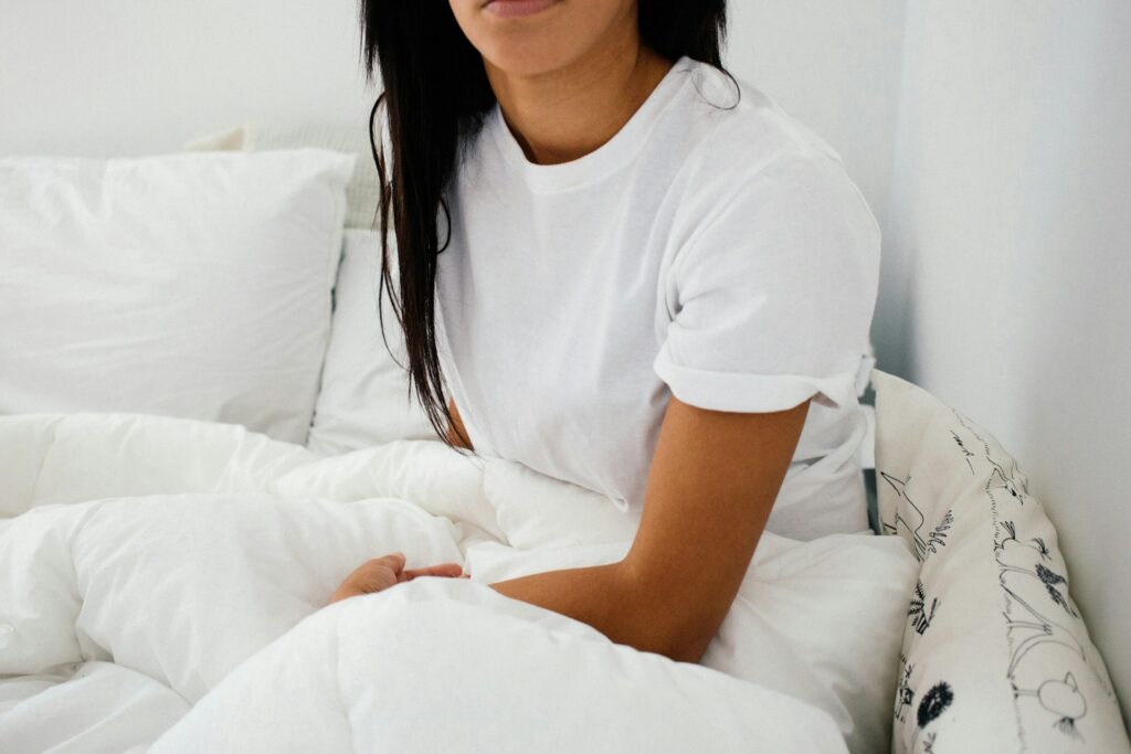 A woman sitting up in bed. 