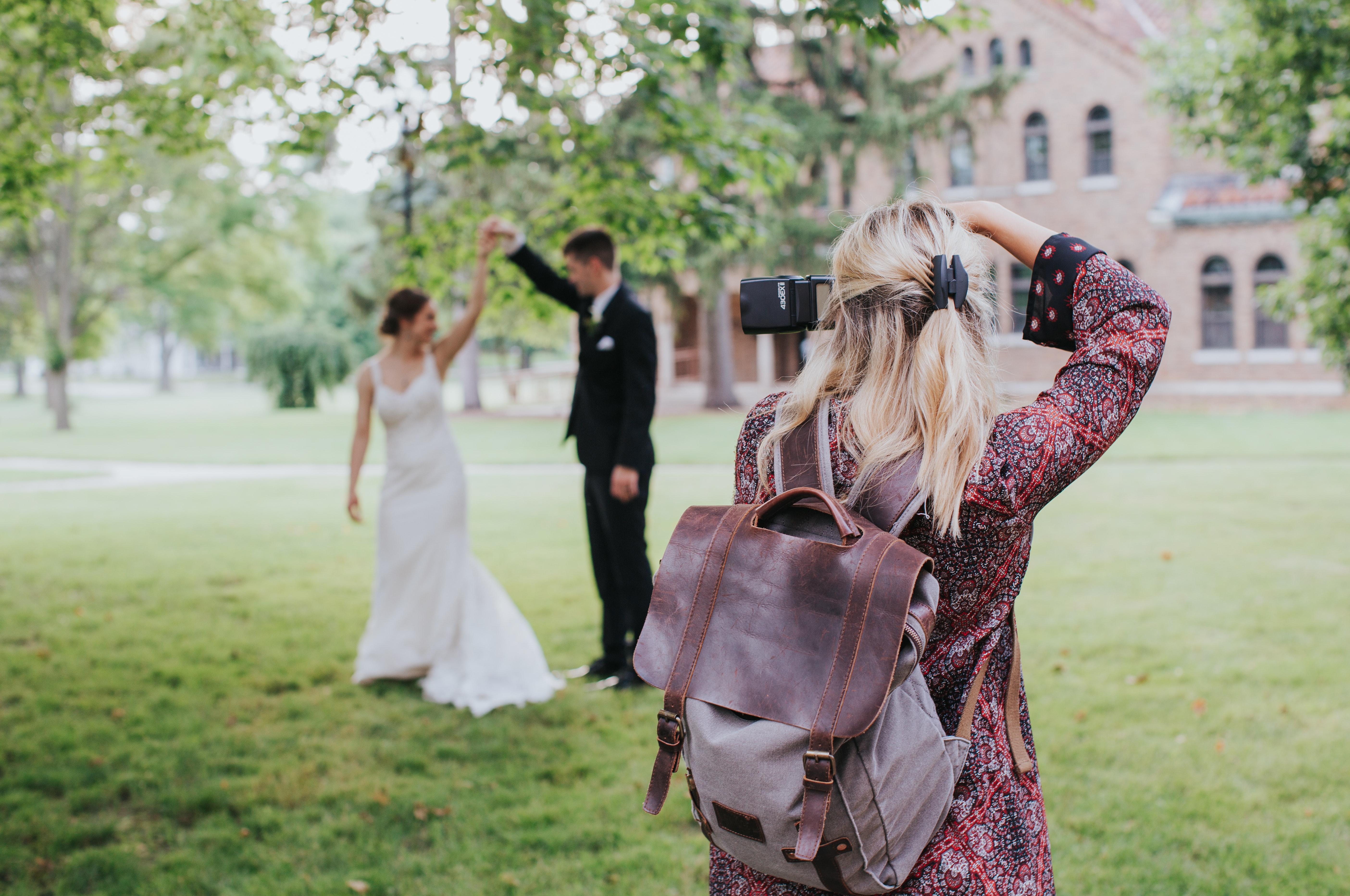 A photographer takes a photo of a bride and groom.
