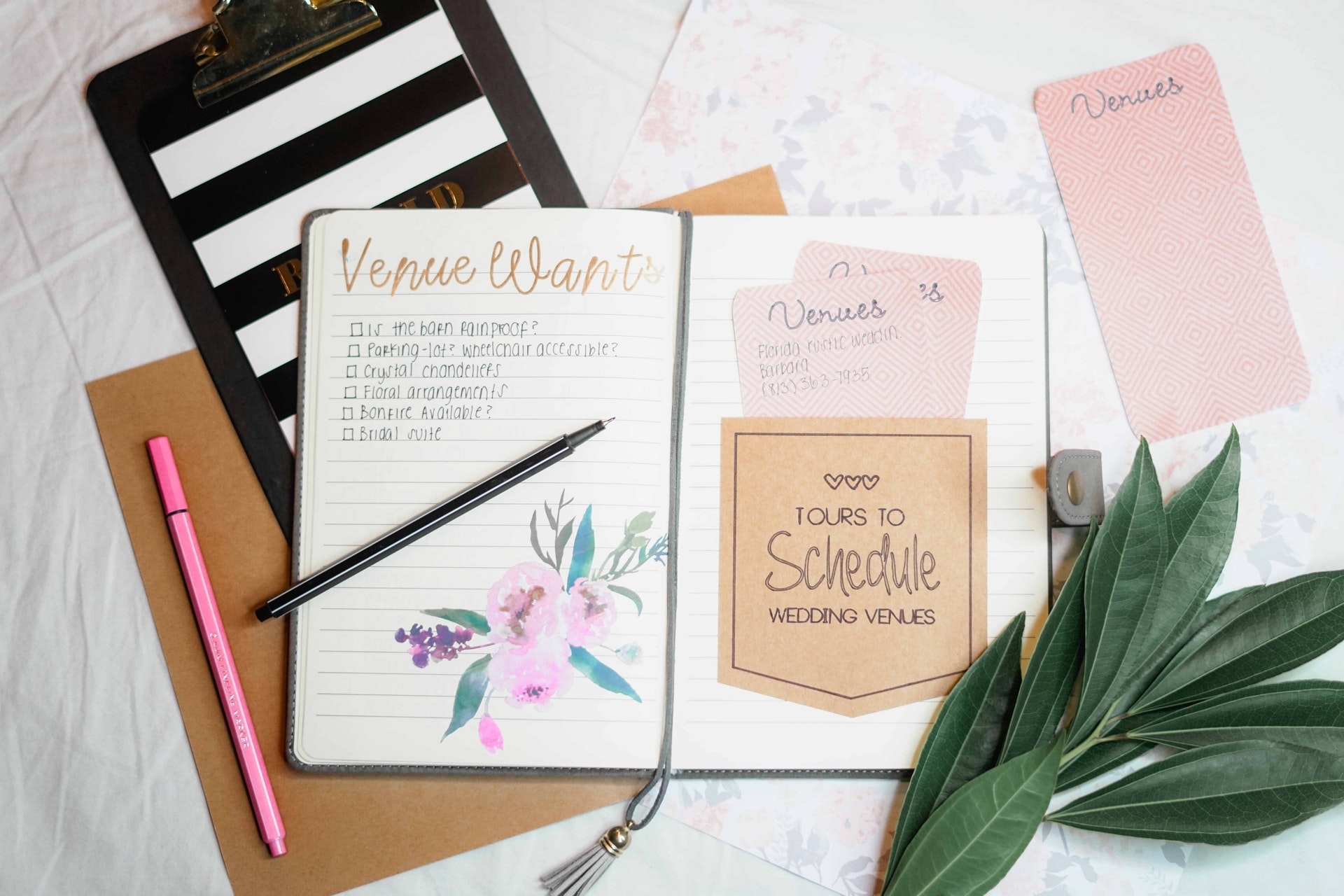 An open notebook contains a wedding planner's notes.