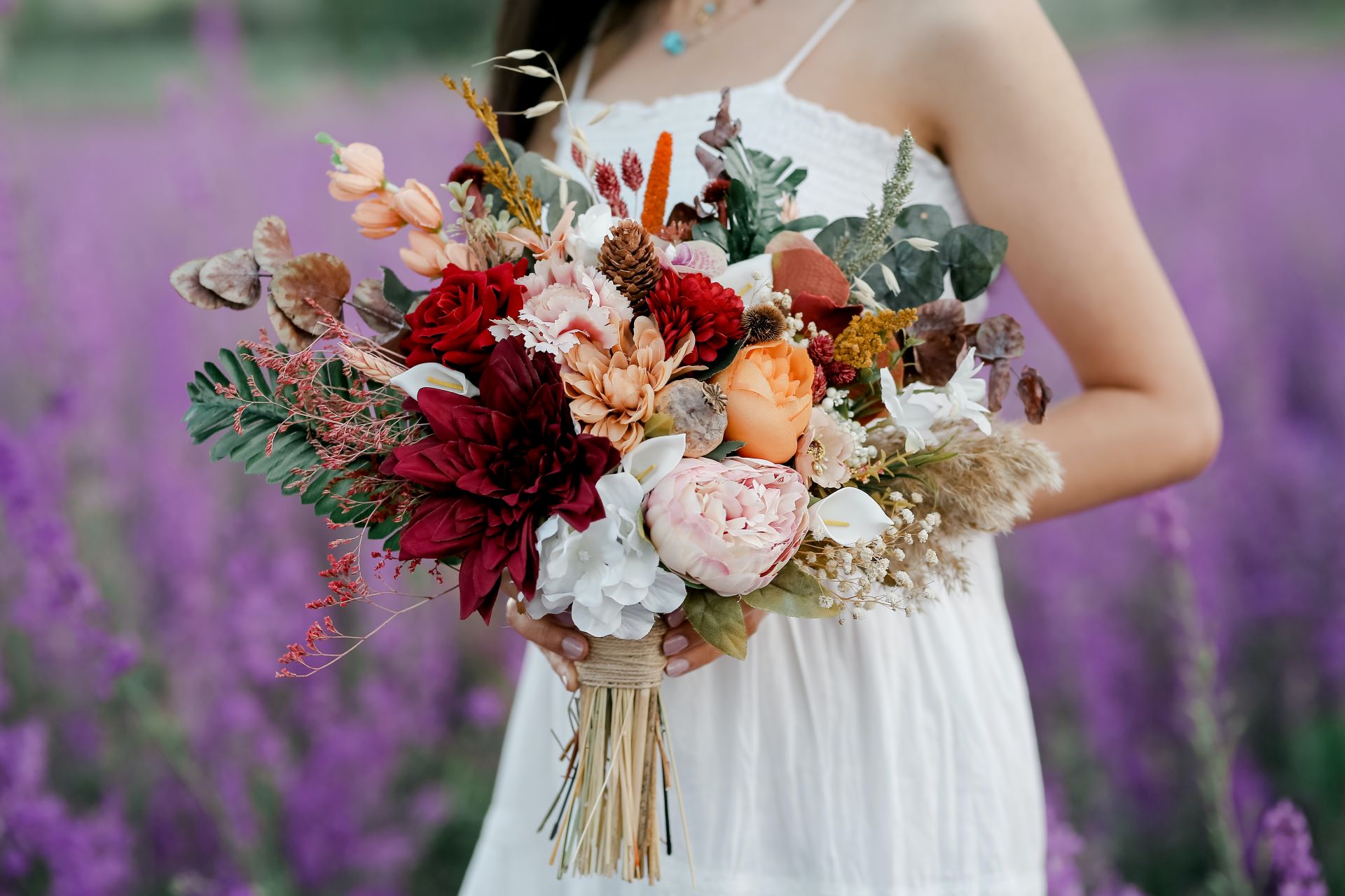 Colorful wedding bouquet in lavendar field