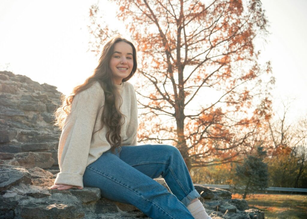 A woman wearing jeans and a sweater. 