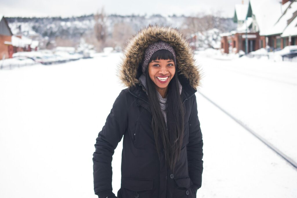 A woman wearing a black winter coat. 