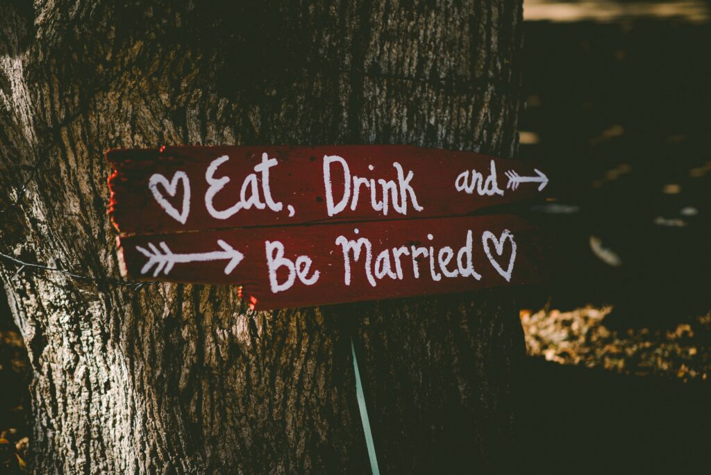 A signpost reads "Eat, drink and be married.