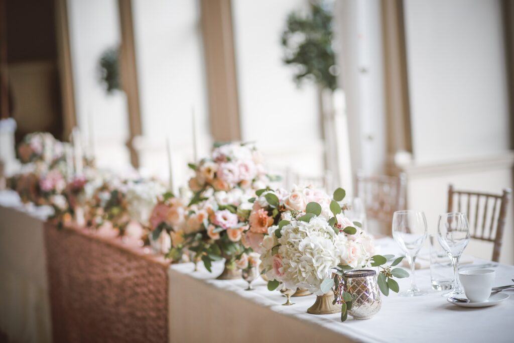 Flower centerpieces decorate a wedding table.