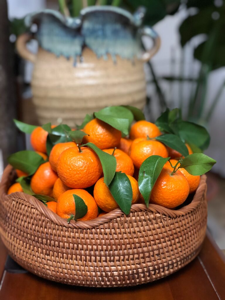 Oranges in a basket as a centerpiece.
