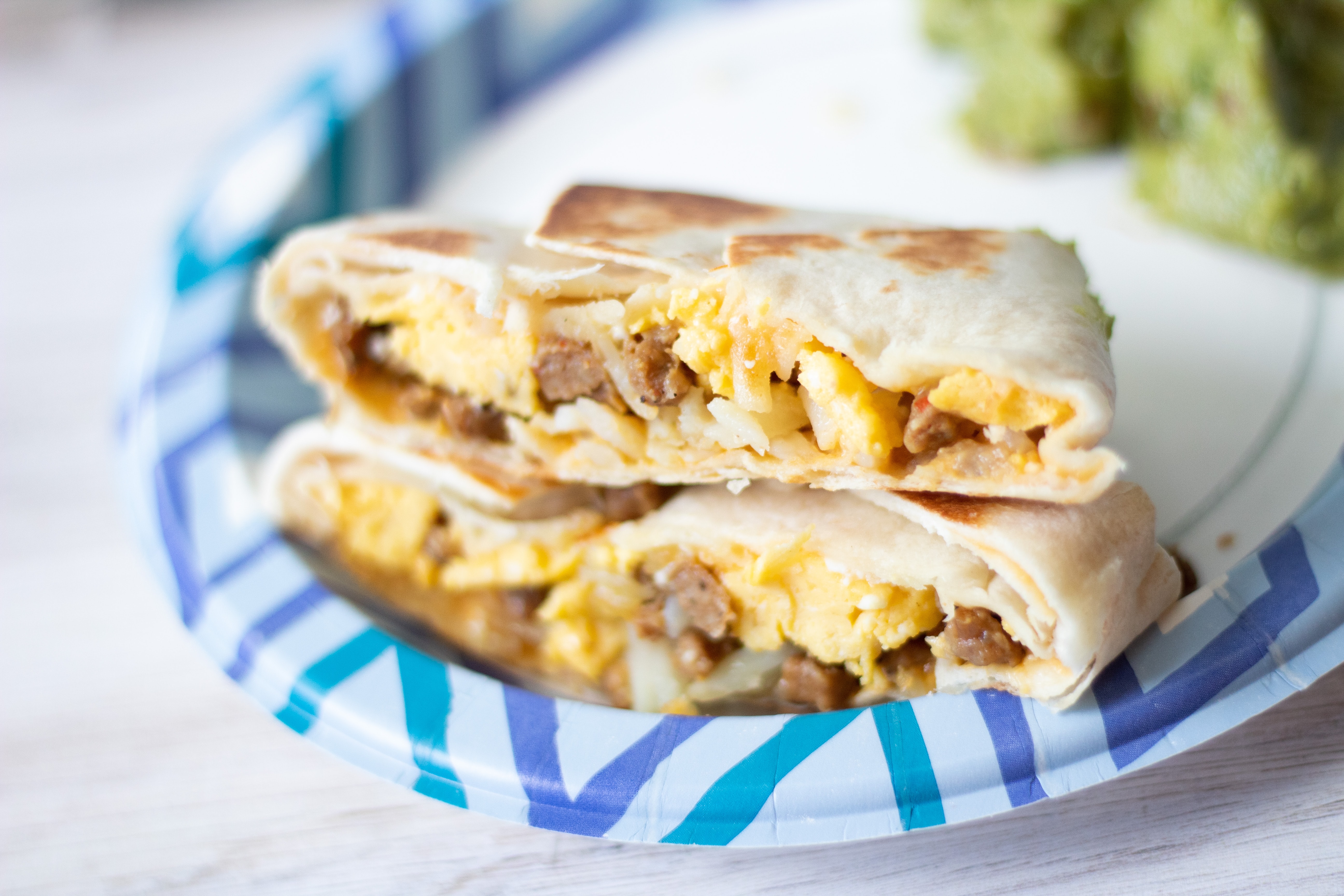 A breakfast burrito filled with egg and meat. 