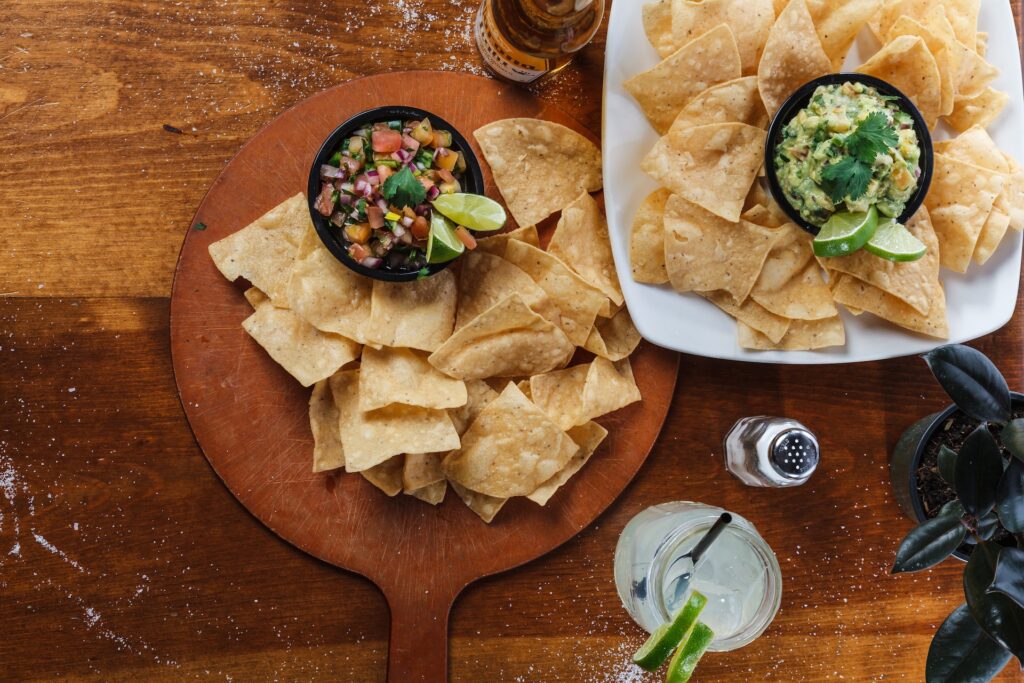 Chips and salsa on a wooden board.