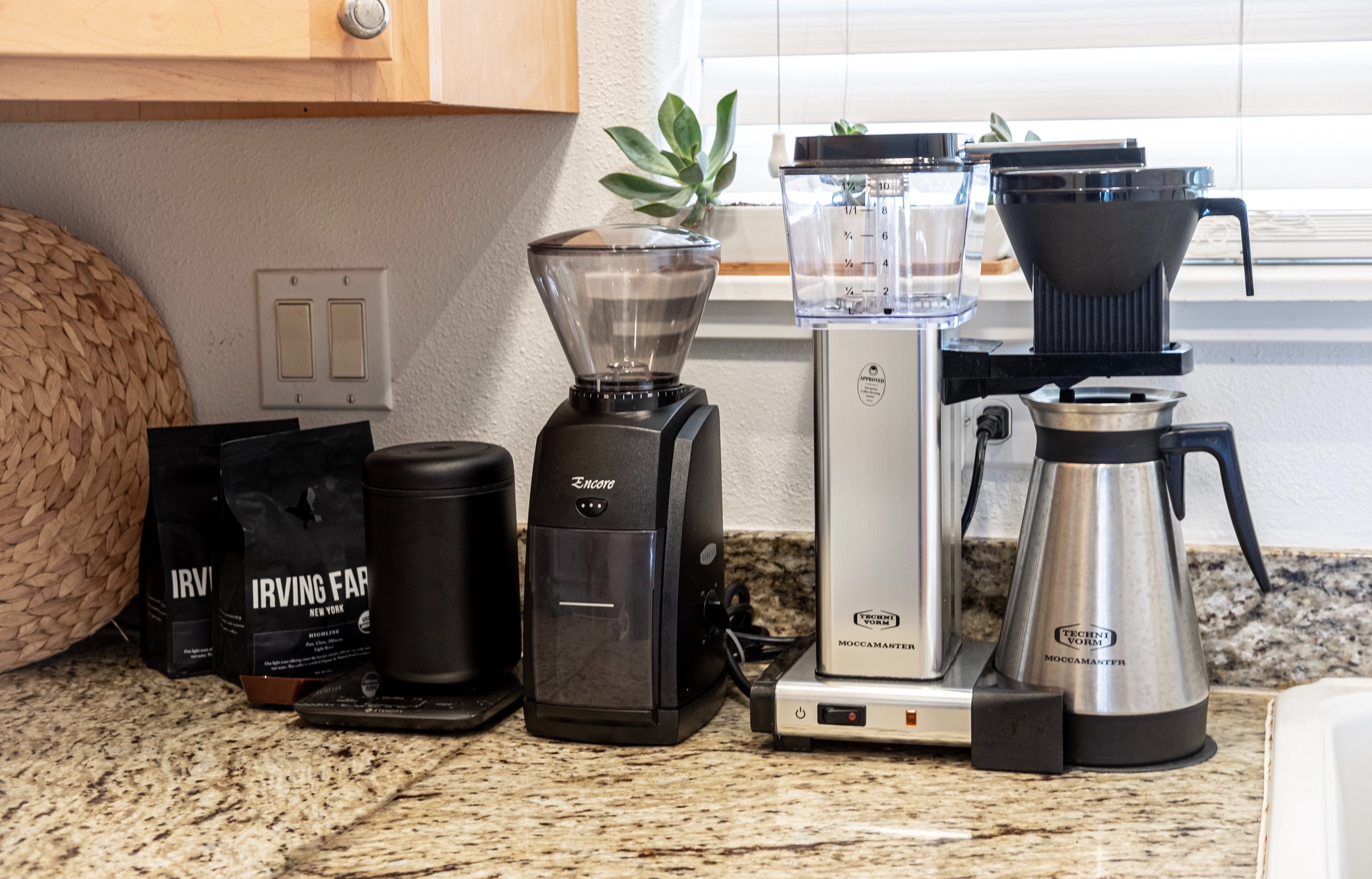 A coffee machine and other appliances sit on a kitchen counter.