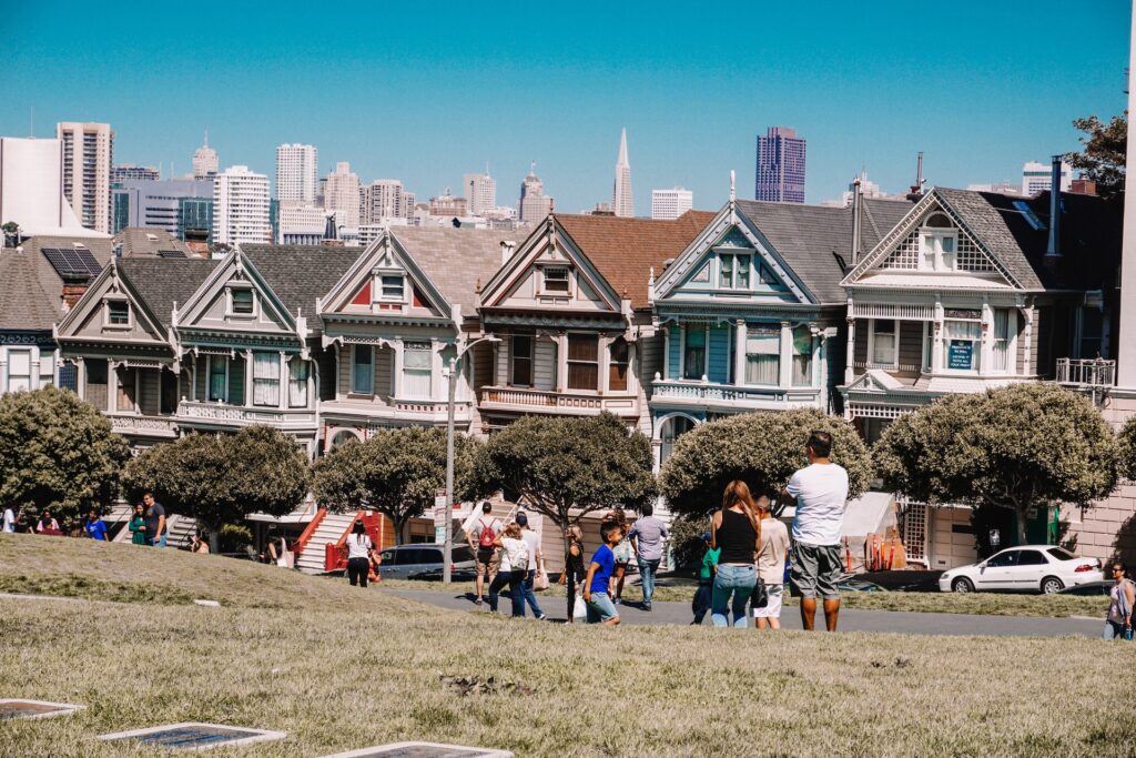 People walk through a neighborhood in San Francisco.