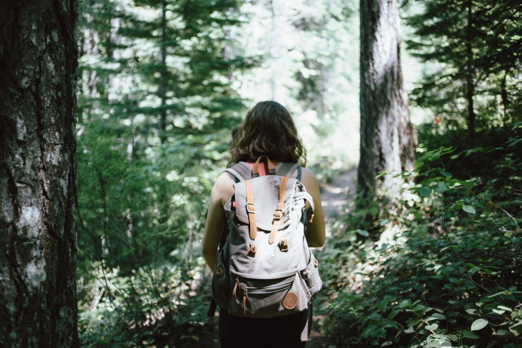 A woman hiking in a forest.