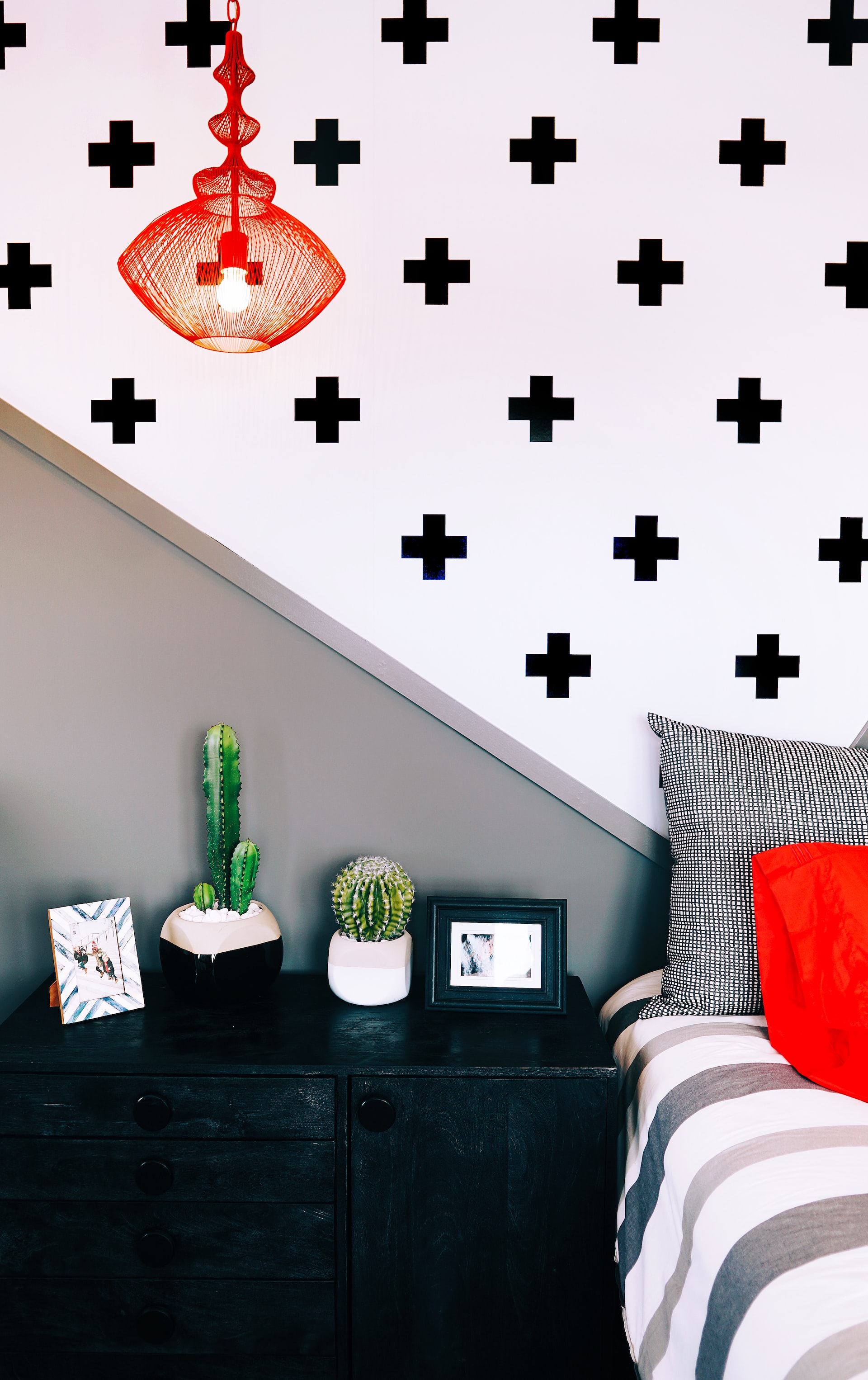 Wallpaper with black cross shapes in a bedroom.