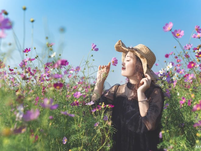 spring break outfits - a woman smelling flowers