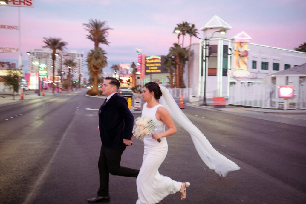 A bride and groom on a street in Las Vegas.