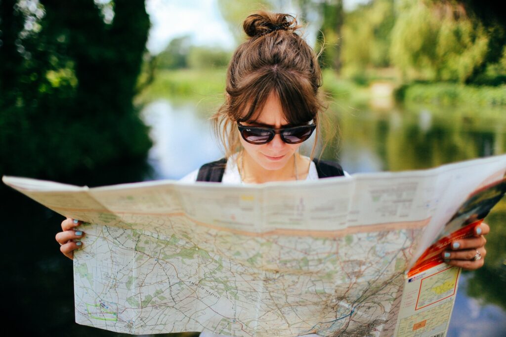 A woman holds a map open.