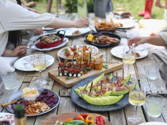A friend group enjoys some of the summer dinner party ideas.