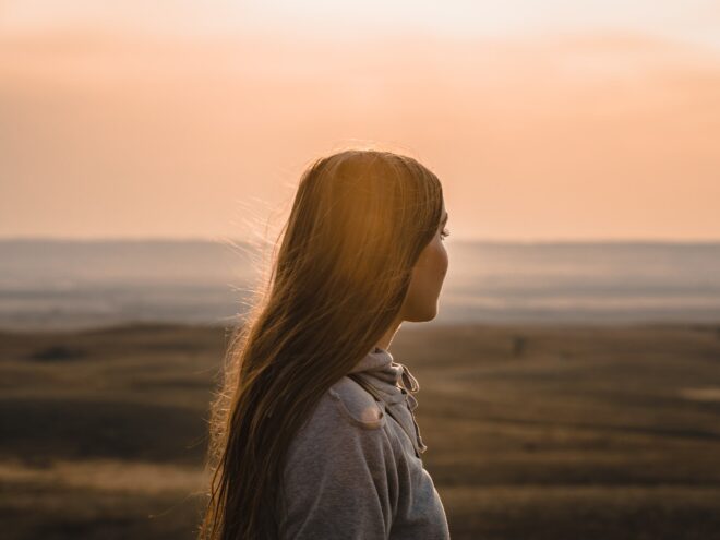 Woman looking at a sunset.
