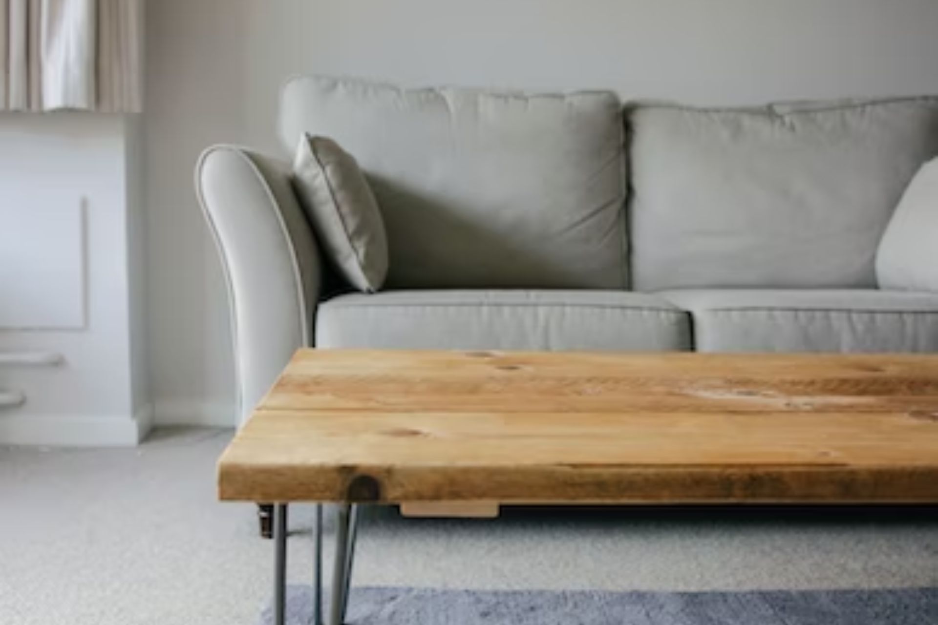 Knwoing where to sell used furniture, like this wood coffee table and gray couch, can help you make money.