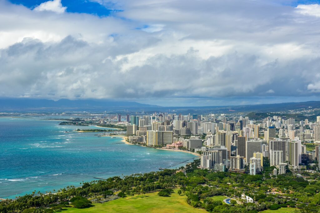 An aerial view of buildings along the beach of Honolulu, Hawaii