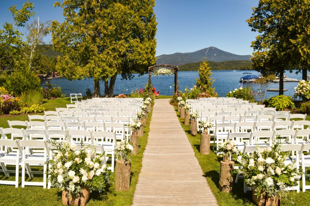 An outdoor wedding venue featuring a brown aisle runner.