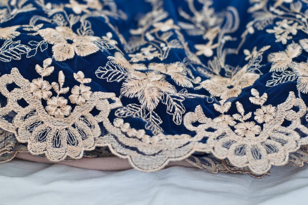Gold embroidery on blue fabric.