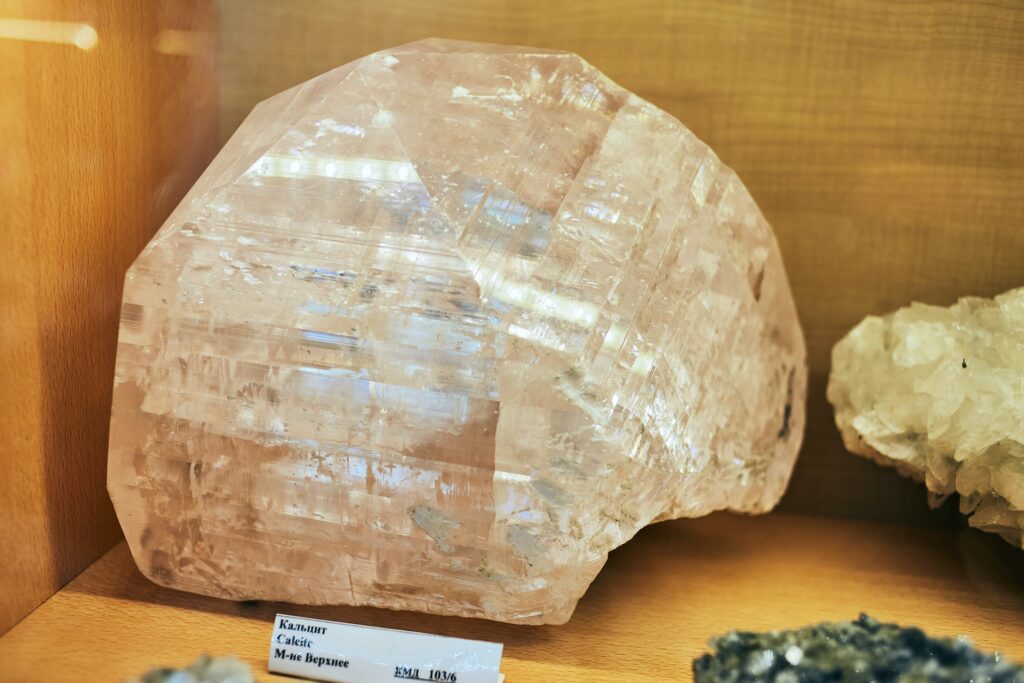 A golden calcite stone displayed in a museum.