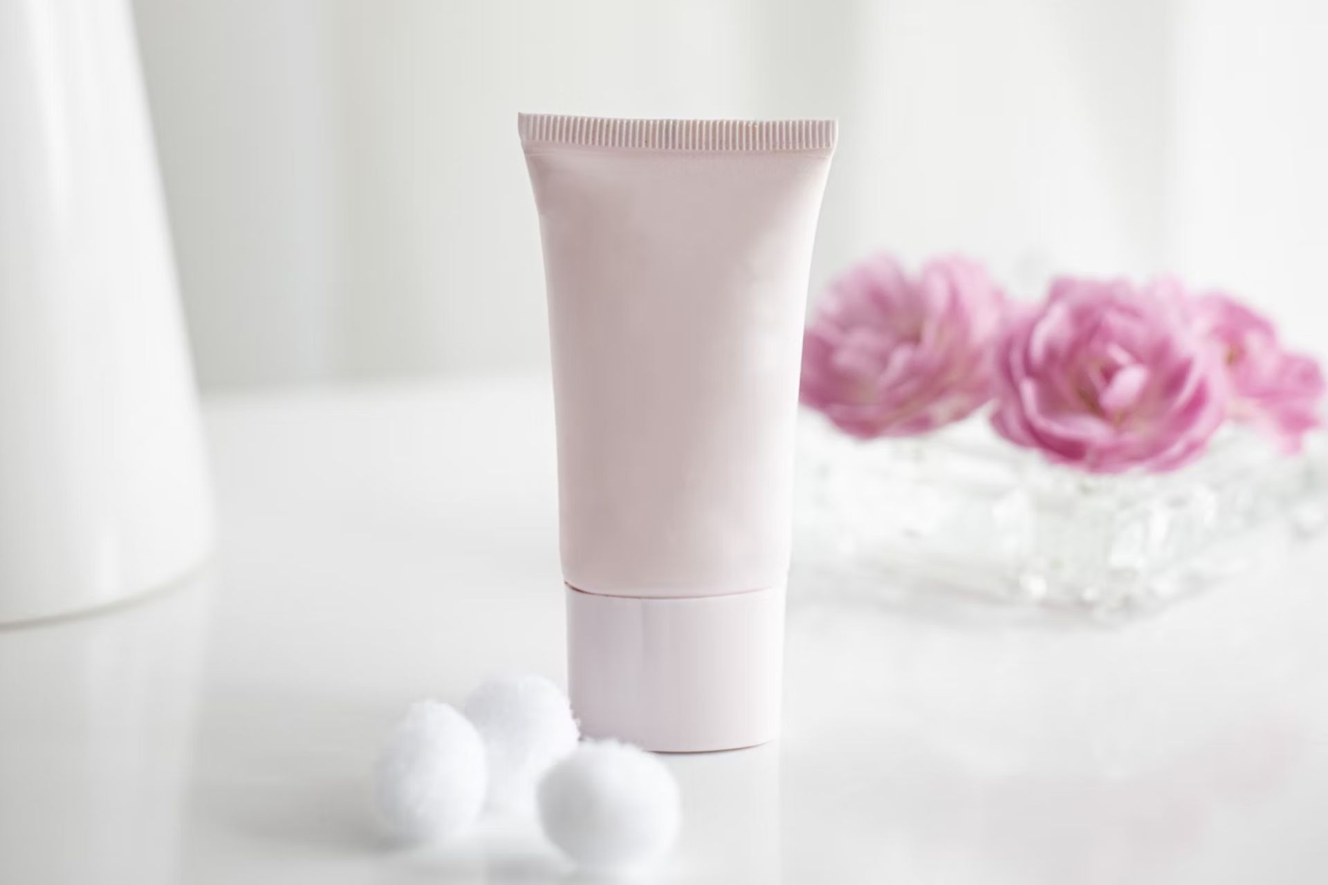 Korean skin care products might be more simplistic and natural than the combinations you're used to -- like this nameless pink tube of cream set against a white background. There are pink roses in a vase in the back, reminding you how fragile your skin is.