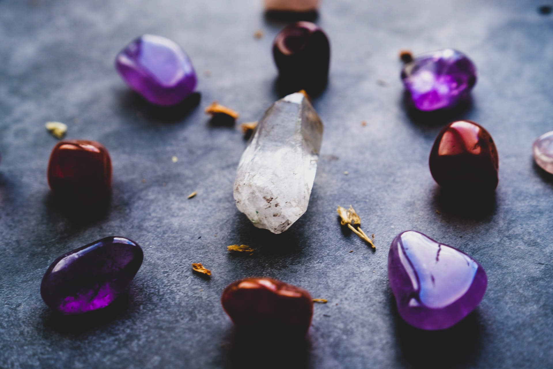 how to cleanse crystals -purple, red and clear crystals on the ground