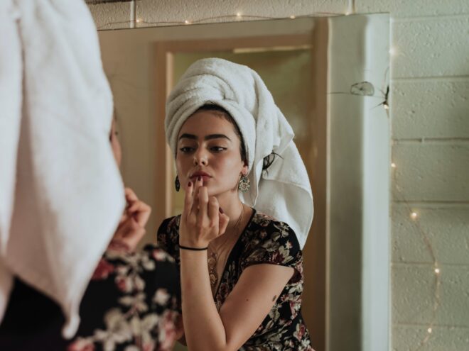 A women doing her skincare routine using the best serums for glowing skin.