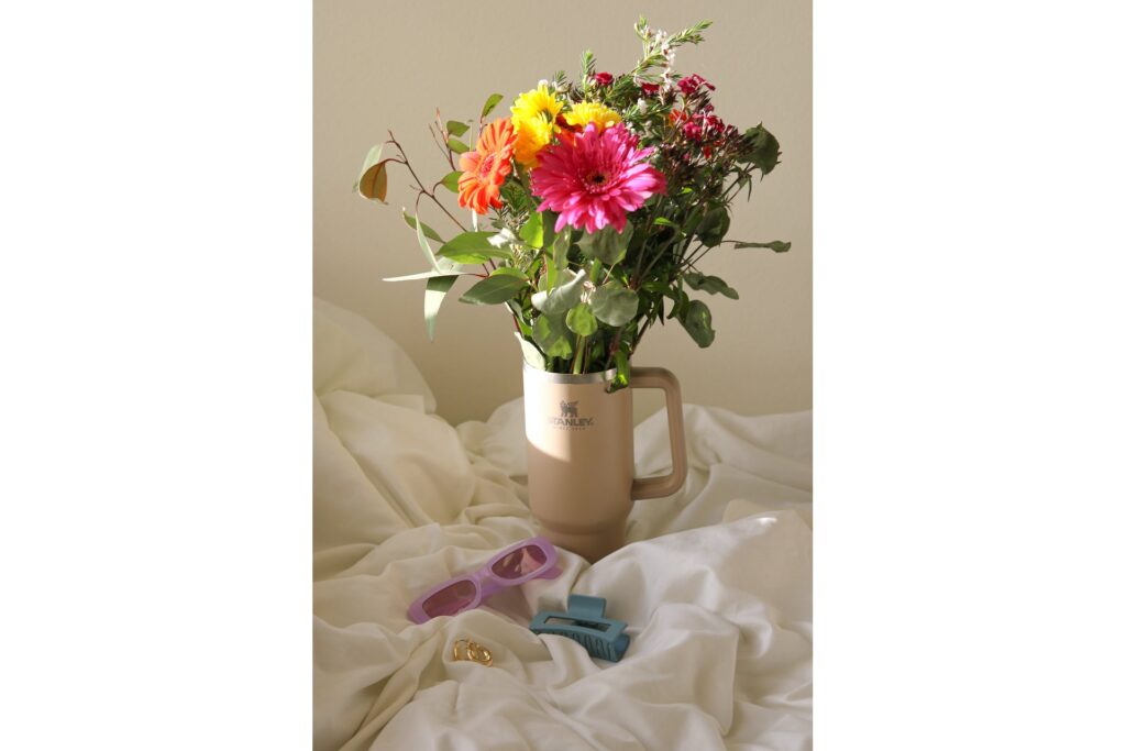 Stanley cup with a bouquet of flowers on crumpled sheets - the perfect Valentine's day arrangement