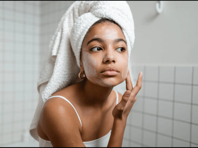 a woman applying skincare on face