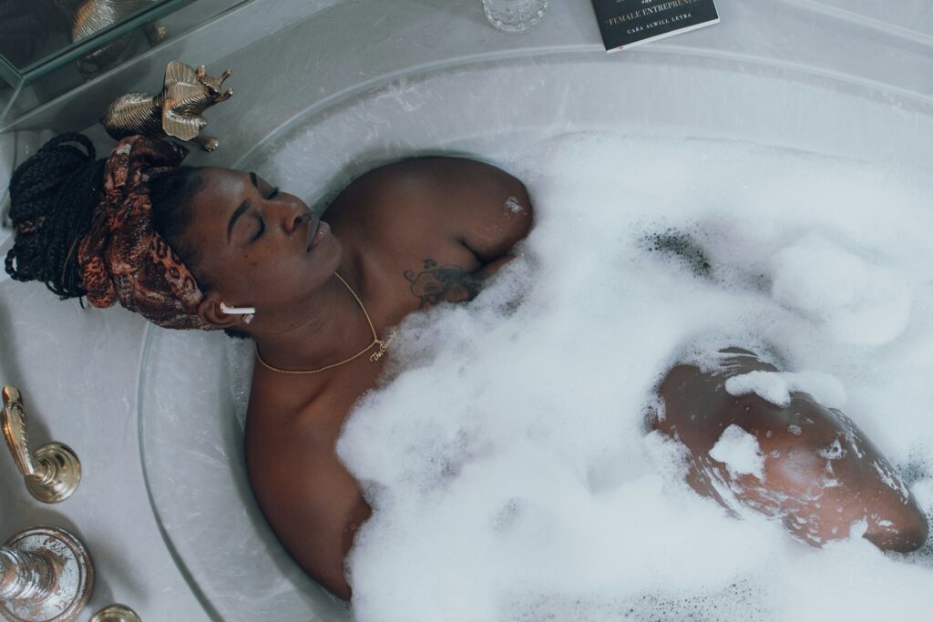 A woman relaxing in a bubble bath.