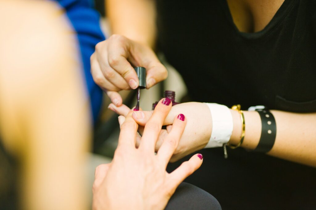 A woman receiving a manicure.
