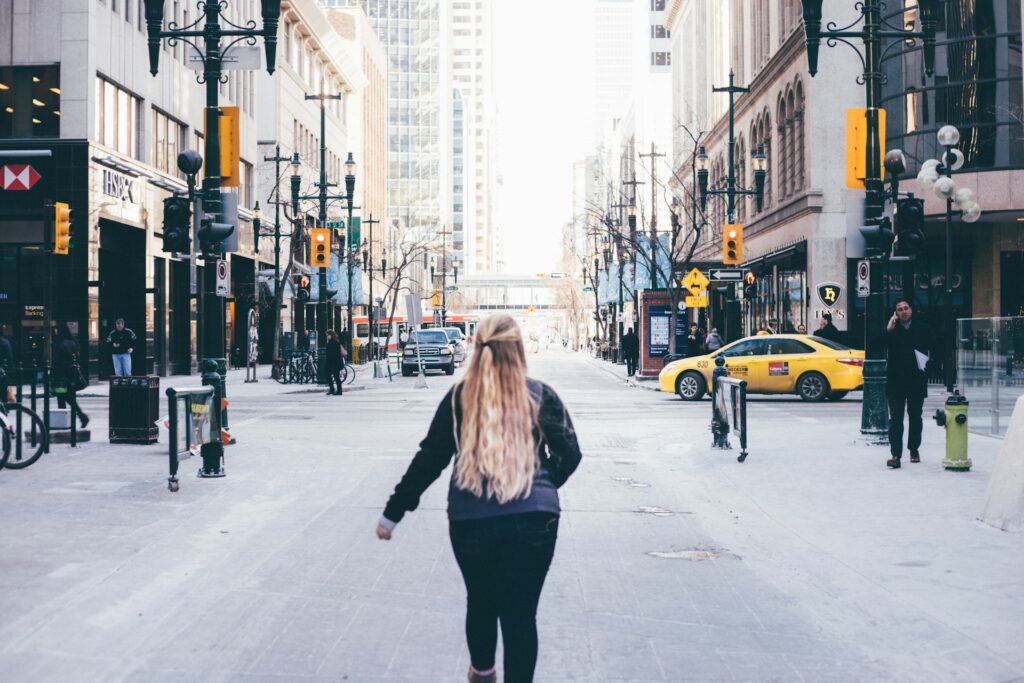 A woman walking around a city.