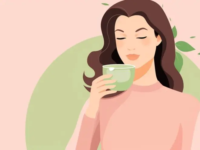 A woman drinking a cup of tea.