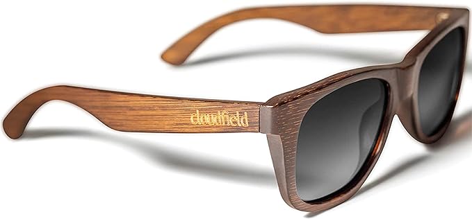 A pair of sunglasses have a dark wooden frame and a dark tint.