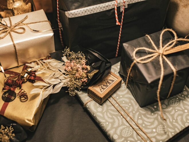 Men's gift guide with a variety of wrapped gifts on a table.