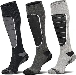 Three wool merino knee-high socks sit against a white background. They're light gray, dark gray and black.