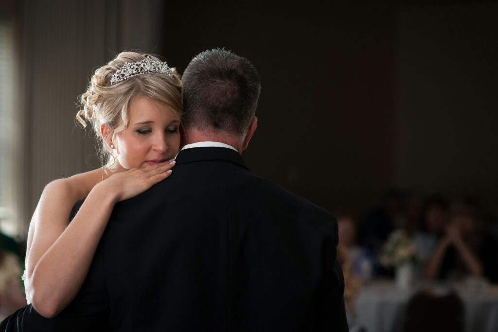 A bride dances with her father.