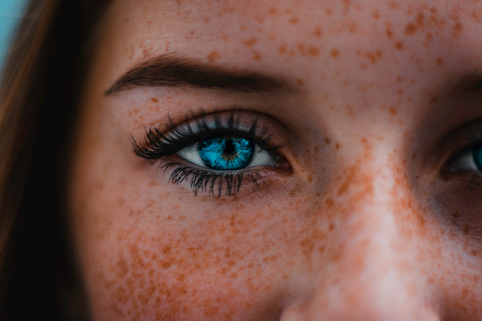 close up of blue eyes and freckles