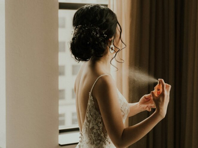 spraying perfume at wedding