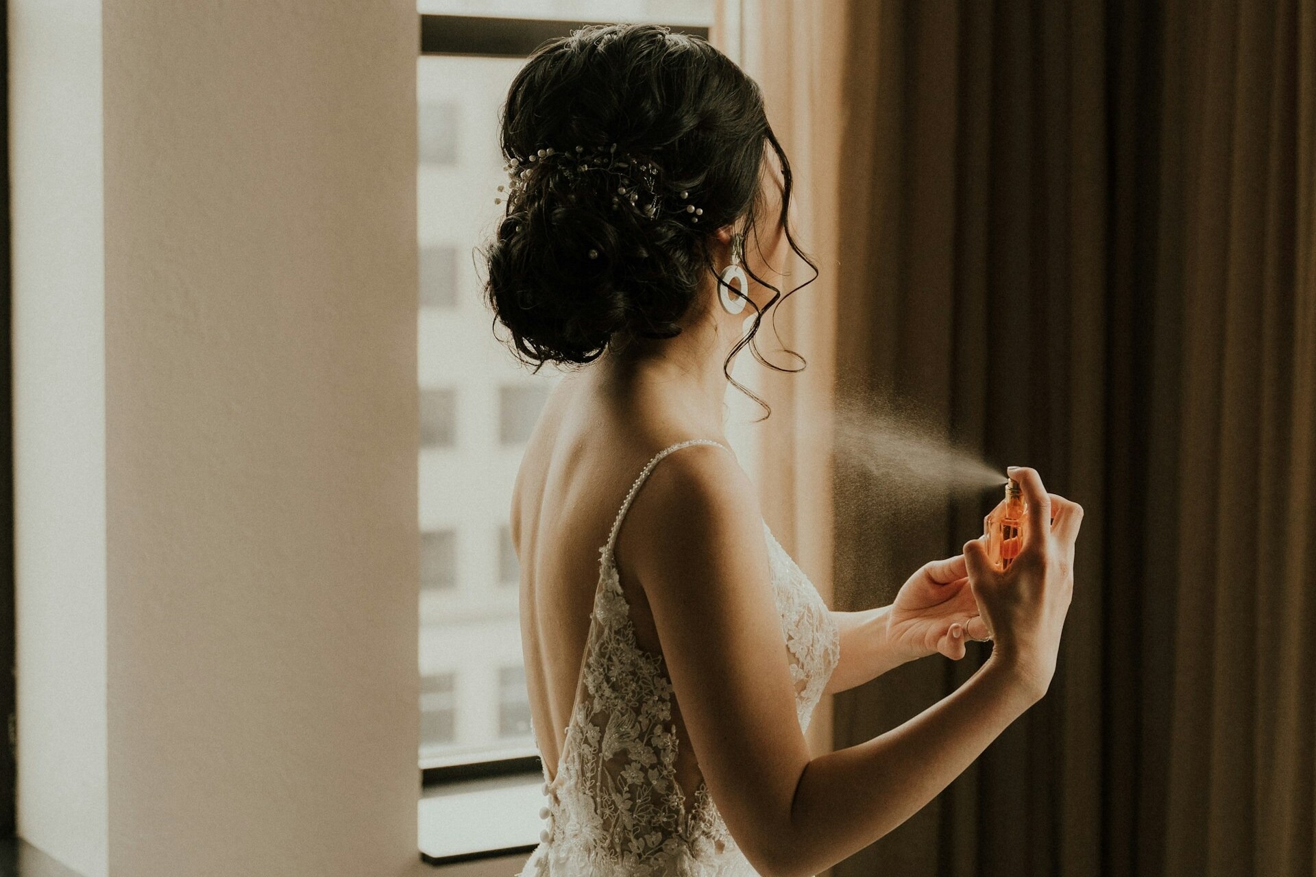 spraying perfume at wedding