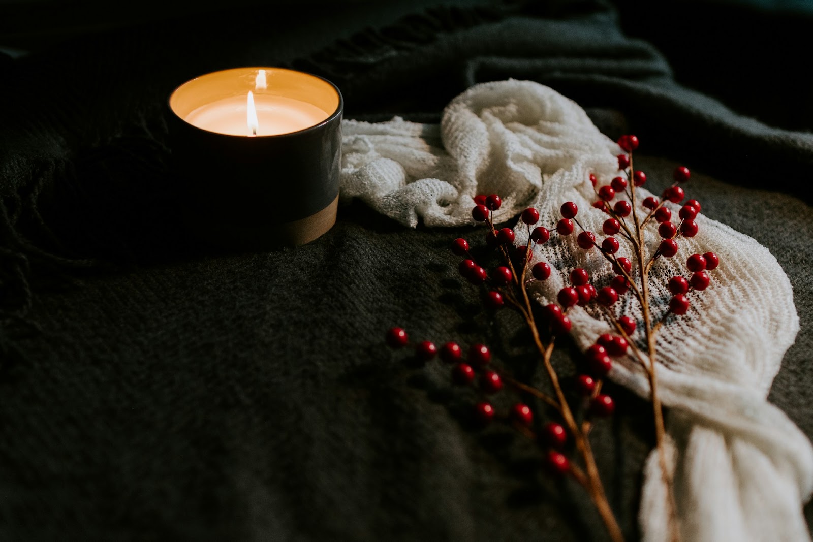 candle and cozy blankets