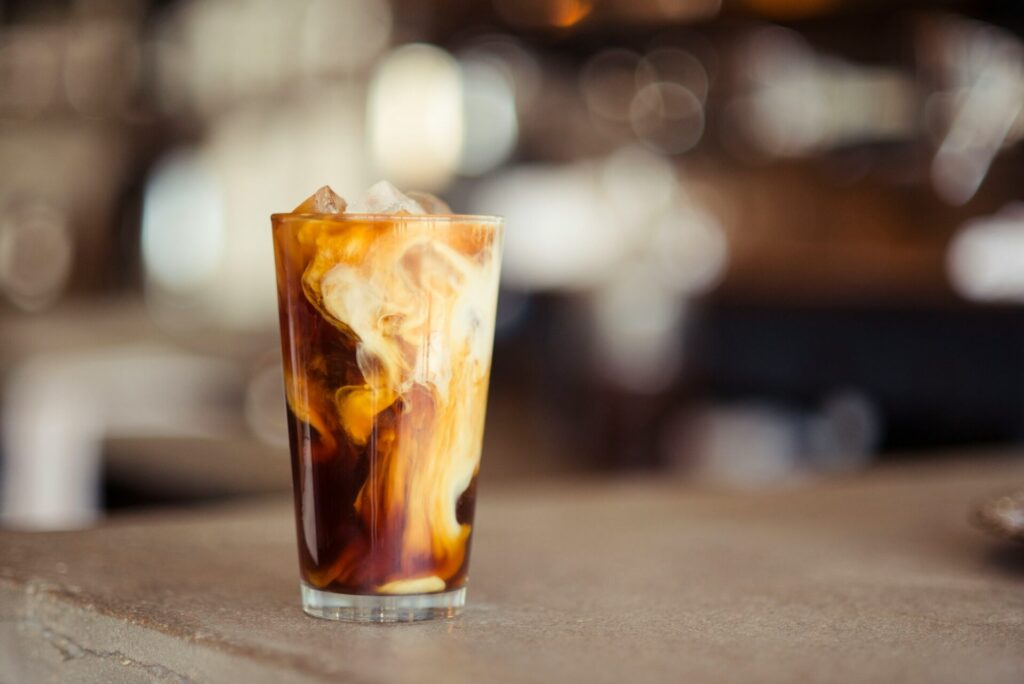 An iced coffee sits pre-mixed on a table