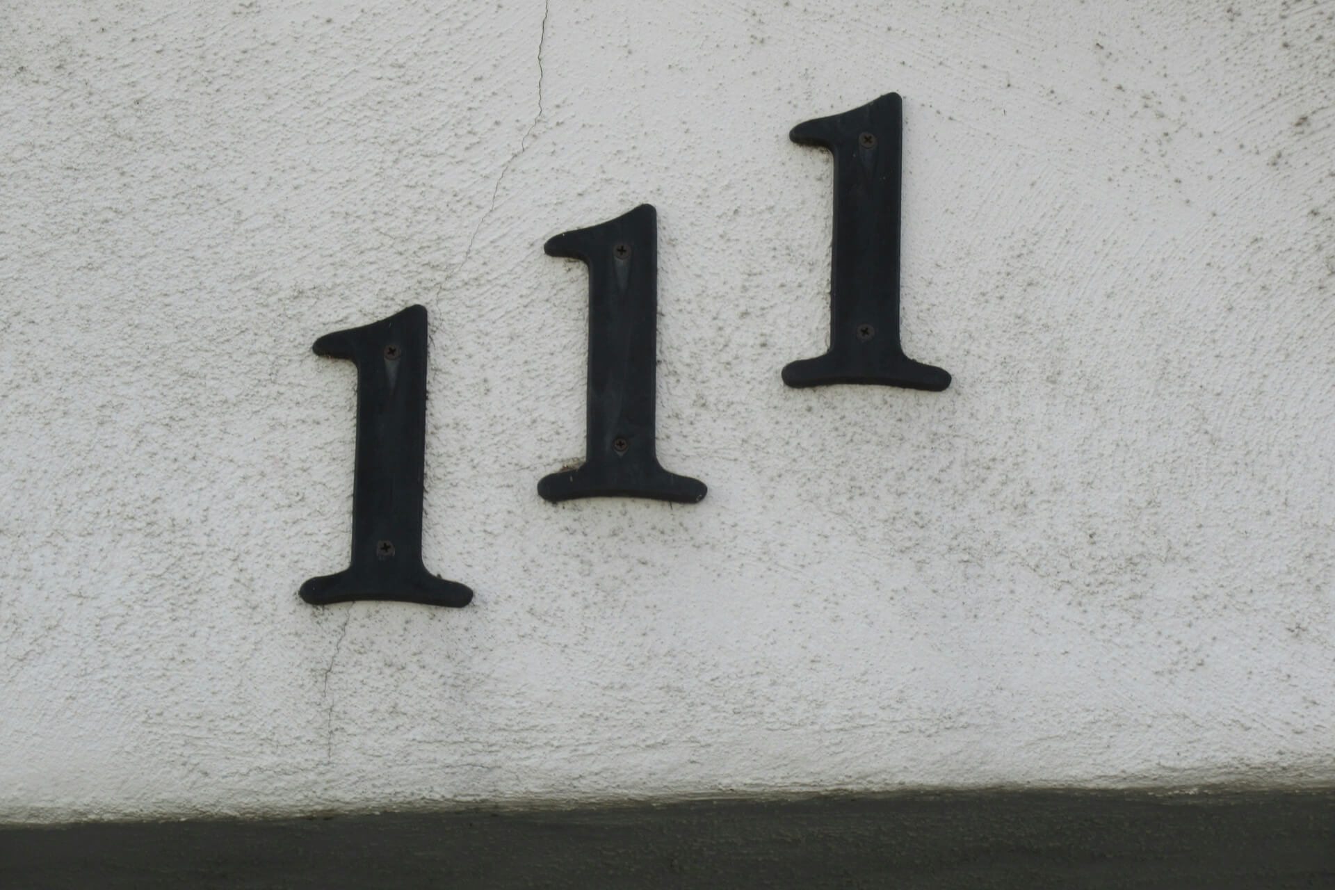 The angel number 111 whose meaning is to start manifesting as per various lists appears as a house number.