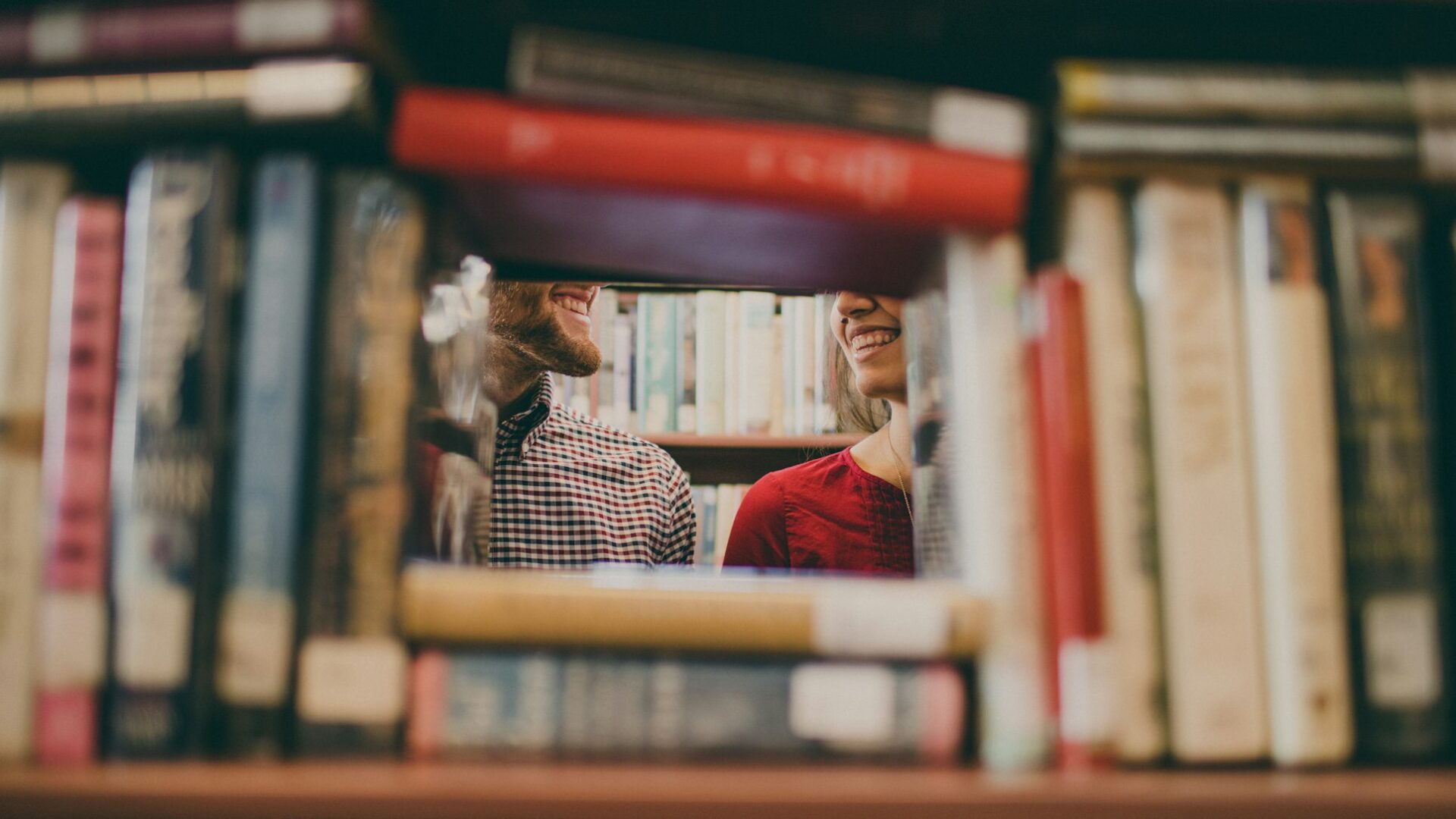 couple smiling in a library 