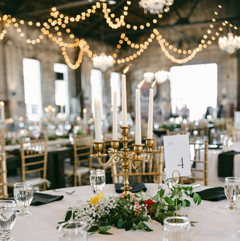 A table set with a golden candelabra and flowers. 