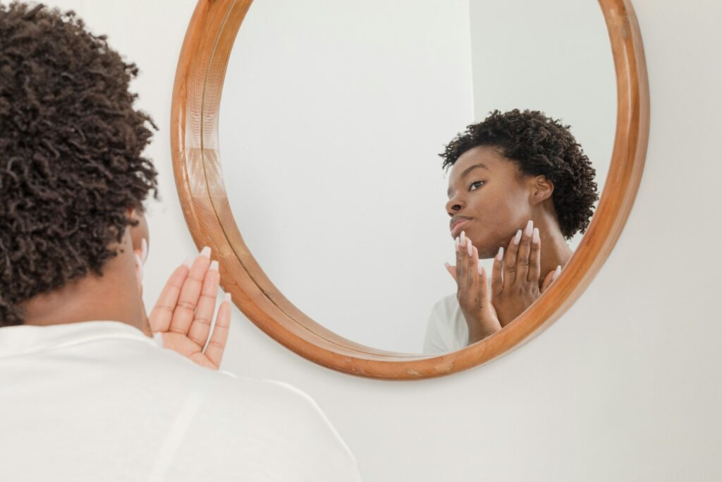 A woman looking in the mirror.