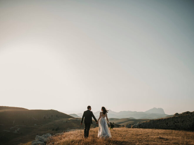 A couple holding hands on their wedding day