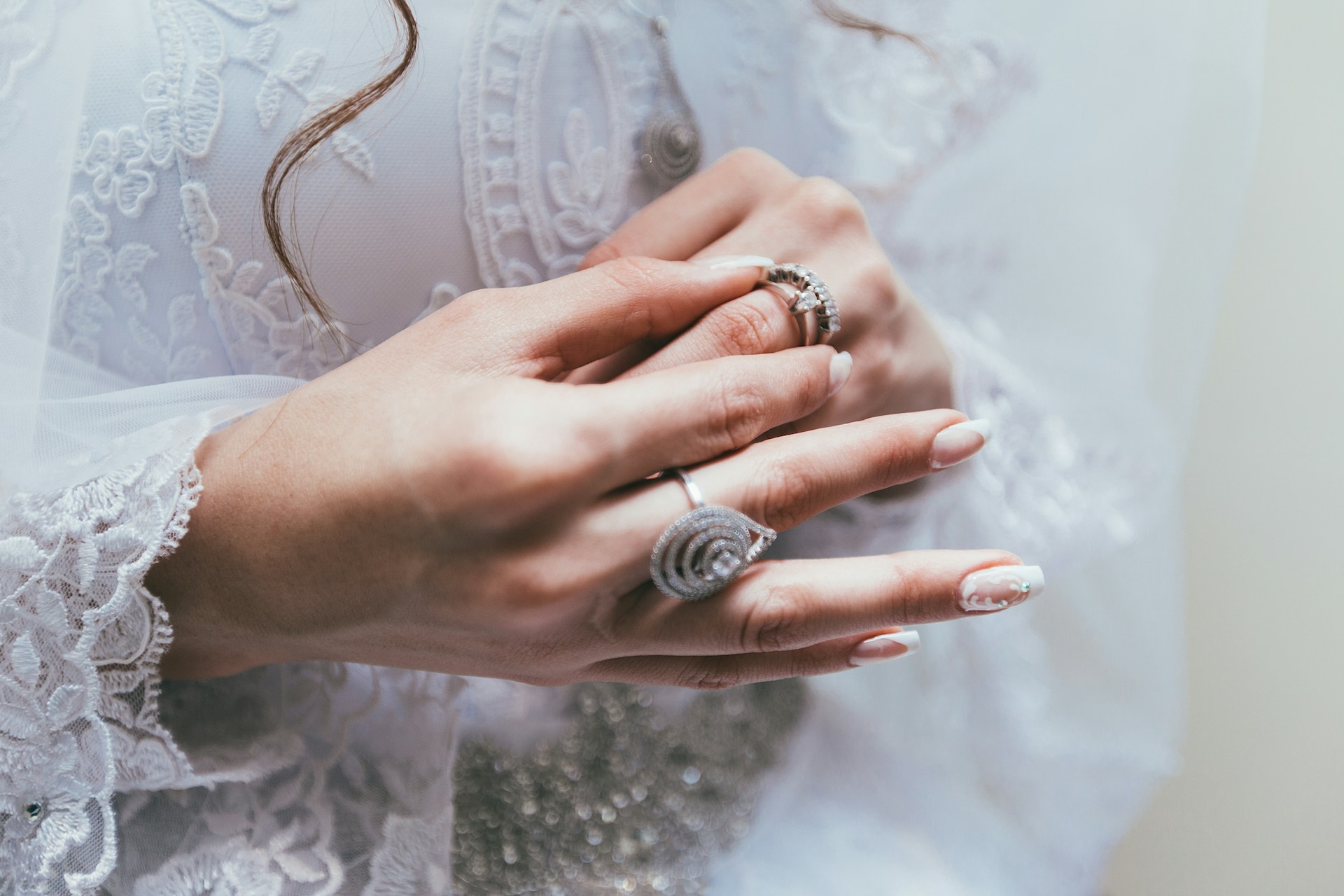 Lady placing a wedding ring stack.